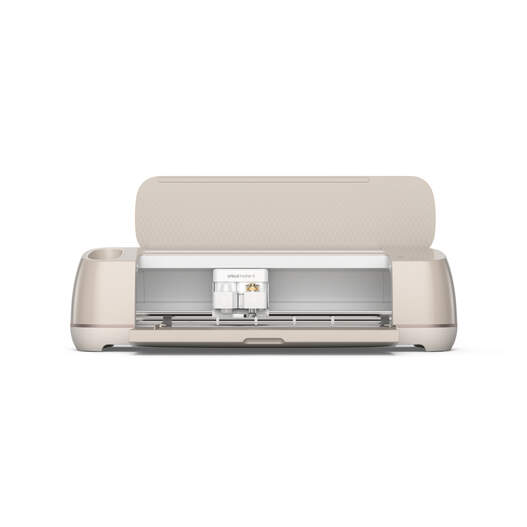 A beige electronic cutting machine with an open lid, revealing its interior blade and tool holder, designed for crafting and DIY projects.