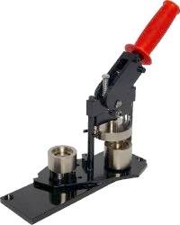 A metal button maker machine with a red handle, black base, and silver pressing components, used for assembling custom buttons.