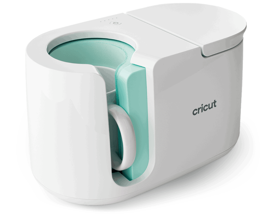 A white Cricut mug press machine with a handle, shown with a white mug inside. The machine has a clean, modern design and cricut branding on the side.