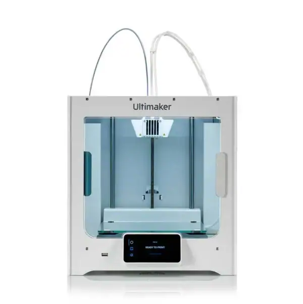A white Ultimaker 3D printer with a transparent front panel, dual extrusion system, and a digital display screen on the lower front, shown on a plain white background.